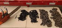 Chainsaw and grouped traction chains on table
