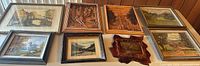 Overview of all eight framed prints and wood plaques on table