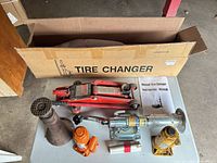Group shot showing all jacks, tire changer box, handles and accessories laid out on table