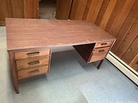 Full view of desk showing top, drawer arrangement and legs