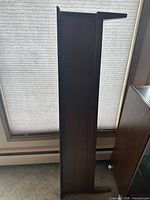 Front view of dark brown veneer footboard standing upright