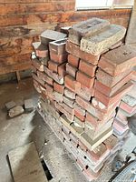 Stack of mixed red clay bricks and a few pavers