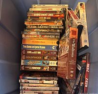 Overall bin showing stacked DVDs, VHS tapes and The Waltons box set