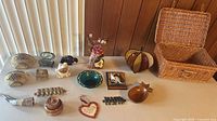 Full layout of all decorative items including wicker basket, ceramics, wood, metal and glass pieces
