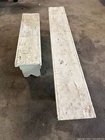 Top view of two white painted wood benches showing lengths and wear