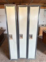 Front view of three tall lockers closed