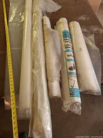 Group shot of five plastic sheeting rolls on wooden table