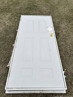 Door lying flat showing six-panel front, knob, lock opening, frame edges