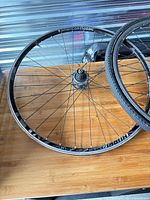 Front wheel overall view showing rim, spokes, and branding