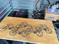Full view of bicycle-shaped wall art on tabletop