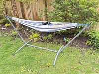 Entire hammock set up on steel stand in yard