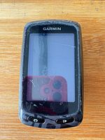 Front view of Garmin Edge 810 showing scratched touchscreen and physical buttons