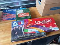 All four boxed games stacked on table