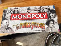 Front of original box showing Monopoly The Three Stooges Collector's Edition graphics