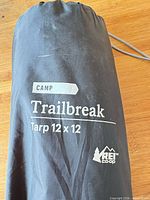 Stuff sack showing REI Trailbreak Tarp 12 x 12 branding