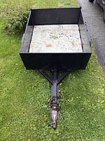 Top view of black steel utility trailer showing bed and tongue
