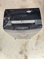 Top view showing Staples logo, paper feed slot, control symbols