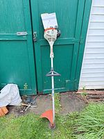 Full view of Stihl FS 38 trimmer with guard and manual