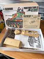 Open Panther Type G kit box with tan plastic hull, turret, sprues, instruction manual visible
