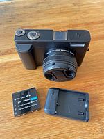 Camera front with battery and charger displayed