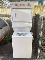 Front view of stacked Whirlpool washer dryer showing overall condition and configuration