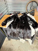 Full view of fur coat showing front, belt and lining
