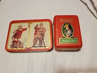 Front view of both Coca-Cola tins closed