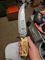 Overall view, left side of engraved blade and carved handle