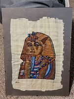 Full view of framed papyrus artwork showing Tutankhamun mask