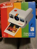 Front of boxed Polaroid Go camera bundle showing product image and branding