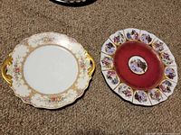 Two decorative porcelain plates side by side on carpet