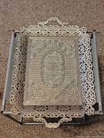 Top view showing ornate filigree border and overall design