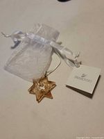 Star ornament, pouch, and branded tag displayed
