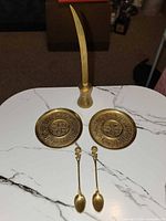 Full set laid out: two dishes, two spoons, letter opener in stand