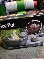 Boxed Green Earth mini fire pot with fuel canister on top