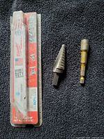 Full lot: packaged Milwaukee Sawzall blade, step drill bit, hex driver bit