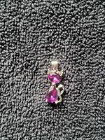 Close-up of cat pendant with purple stones and clear accents