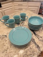 Full dinnerware set arranged showing 4 plates, 4 bowls, 4 mugs
