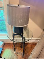 Side table with lamp in situ showing overall form and relation between pieces