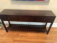 Front view of console table showing drawers and lattice shelf