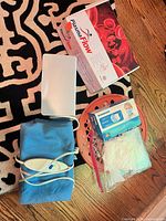 Overall lot showing heating pad, wipes warmer, PlasmaFlow manual, mask box and basket
