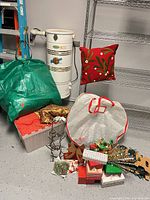 Group shot of decorations including pillow, storage bags, tote, ornaments