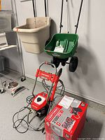 Overall view of Craftsman pressure washer, Scotts spreader and beige tow hopper spreader