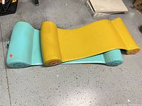 Turquoise and yellow Sun Cliner foam float on floor