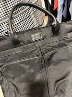 Front view of Tumi briefcase showing material, handles and exterior pockets