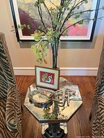 Full view of table top with vase, artwork, bowl, antler