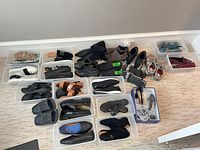 All footwear laid out in clear bins and on floor