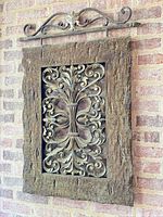 Full view of wall decor hanging on brick wall