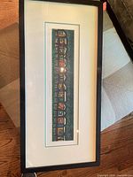 Full view of framed serigraph under glass