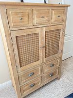 Full view of cabinet showing drawers, mesh doors, metal hardware, finish